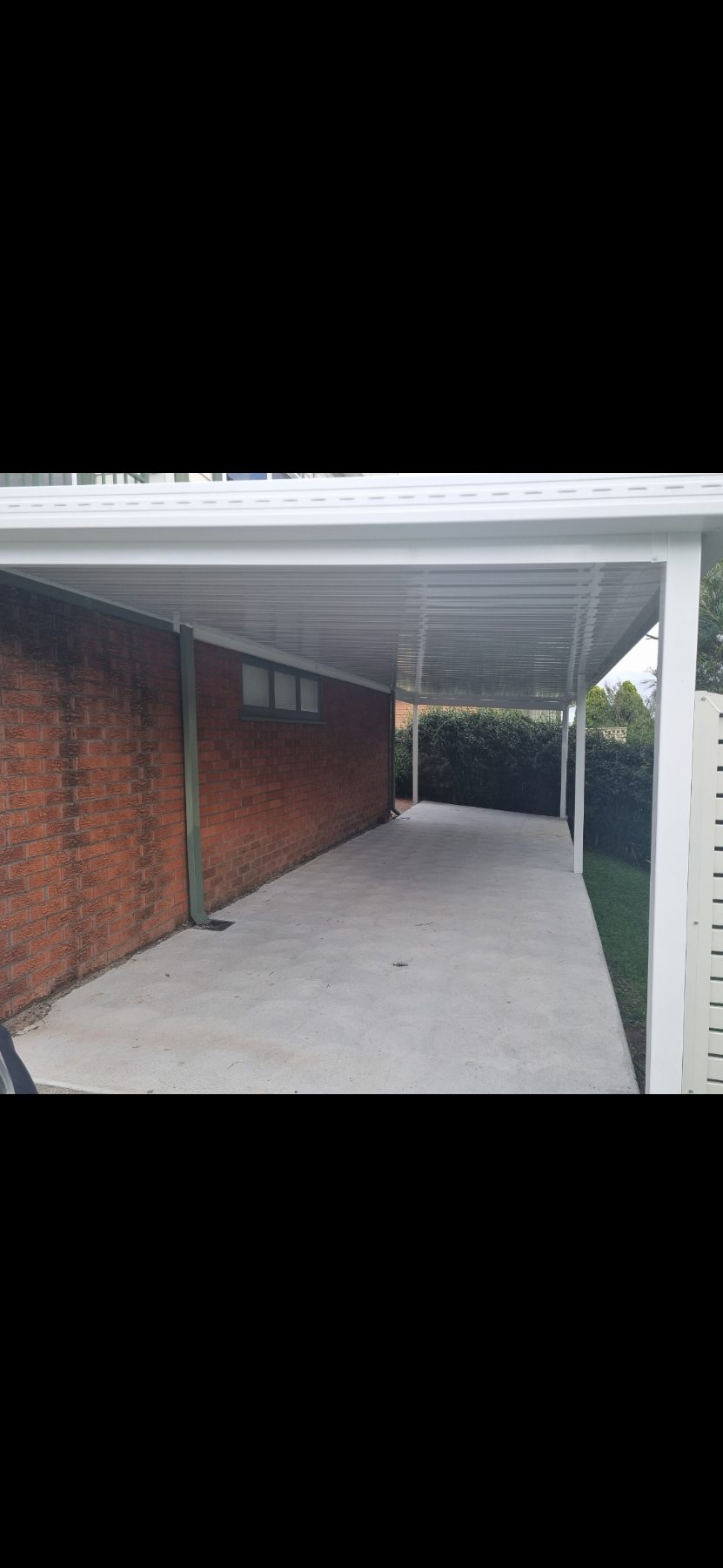 Long attached carport with concrete slab