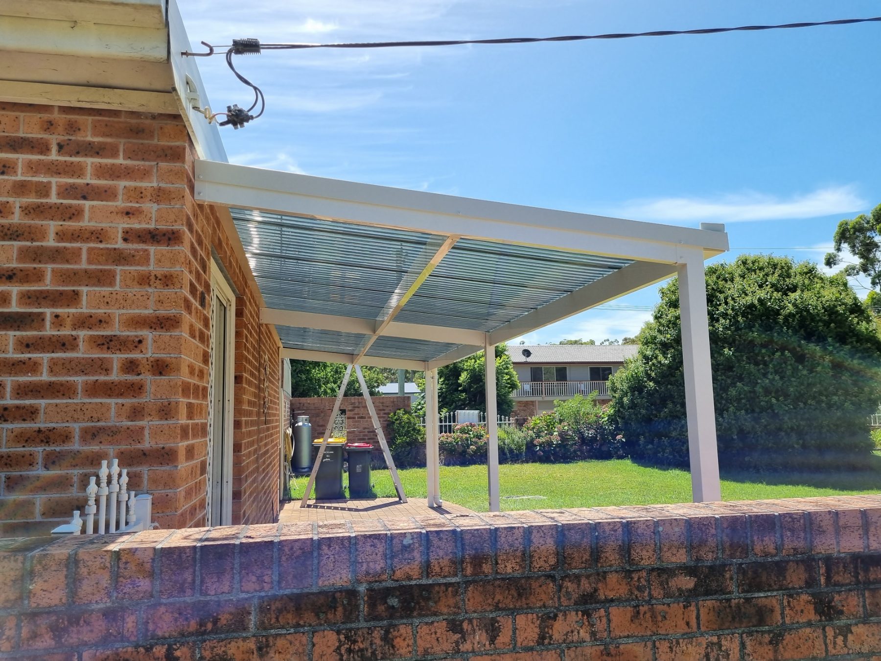 Pergola attached to a brick home